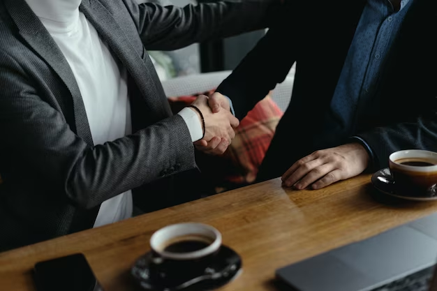 Two people in suits shaking hands