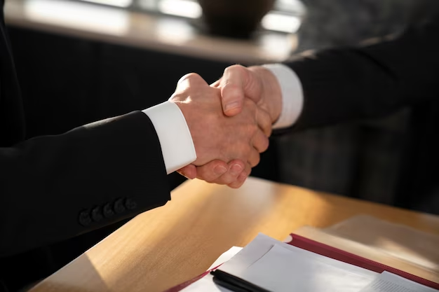 two people in suits shaking hands